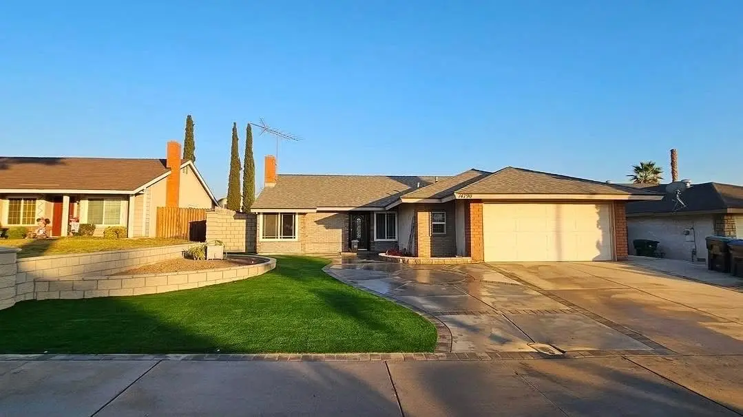 Completed front-yard artificial turf and concrete landscape