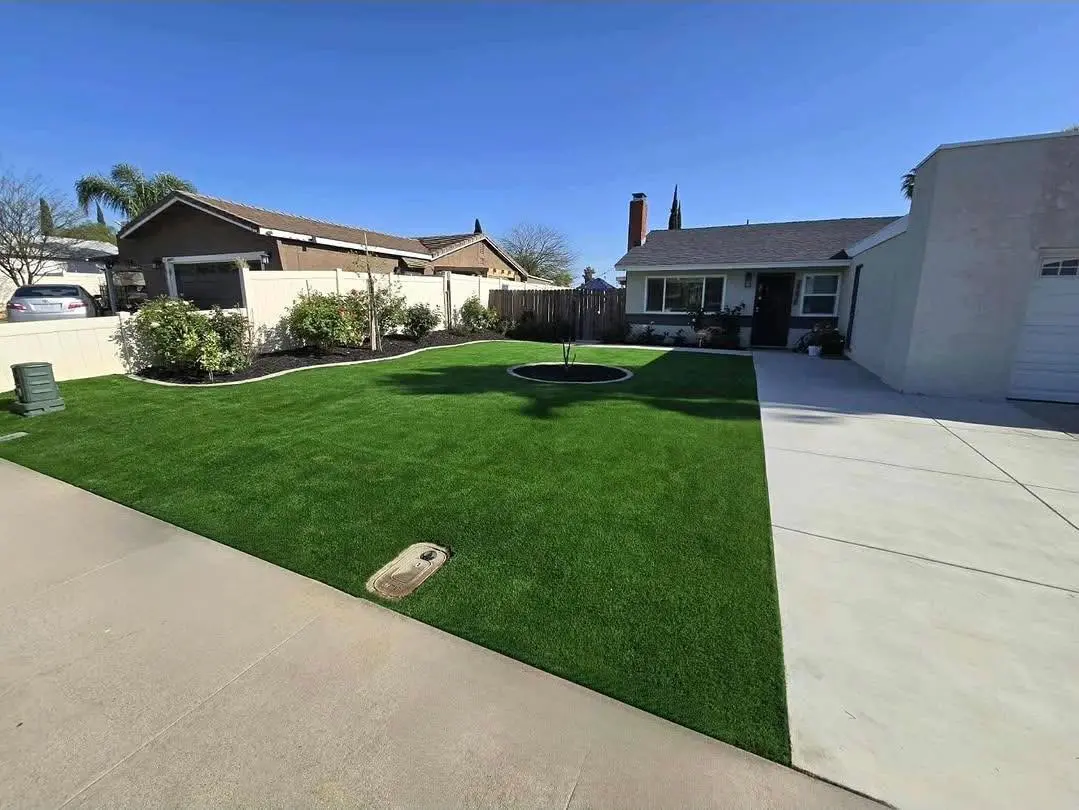 Completed artificial turf lawn with circular tree planter